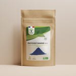 Sachet de superaliment phycocyanine/spiruline bleue Bioptimal présenté sur fond beige.